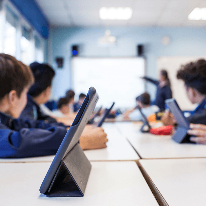A classroom of students using ipads for a lesson